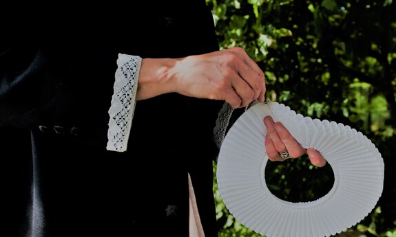 Billede af præst med præstekrave i hænderne i naturen